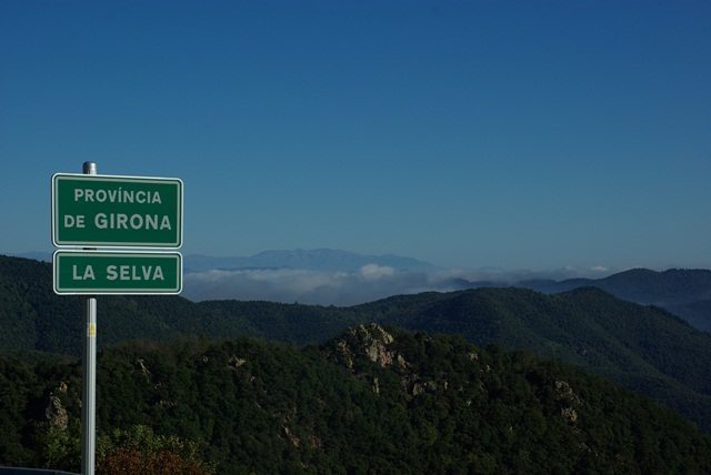 Ranges of mountains with a clear blue sky behind.