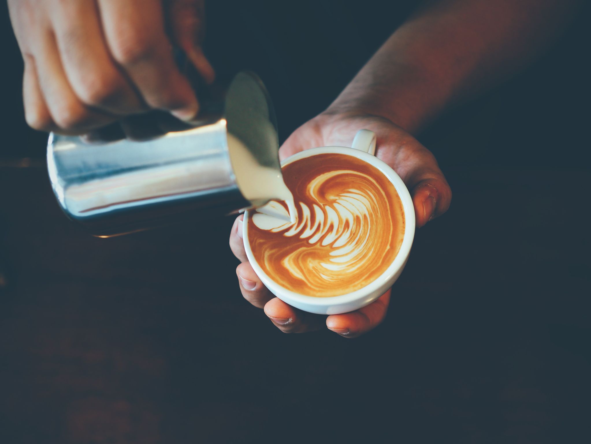 Milk is being poured into a cup.
