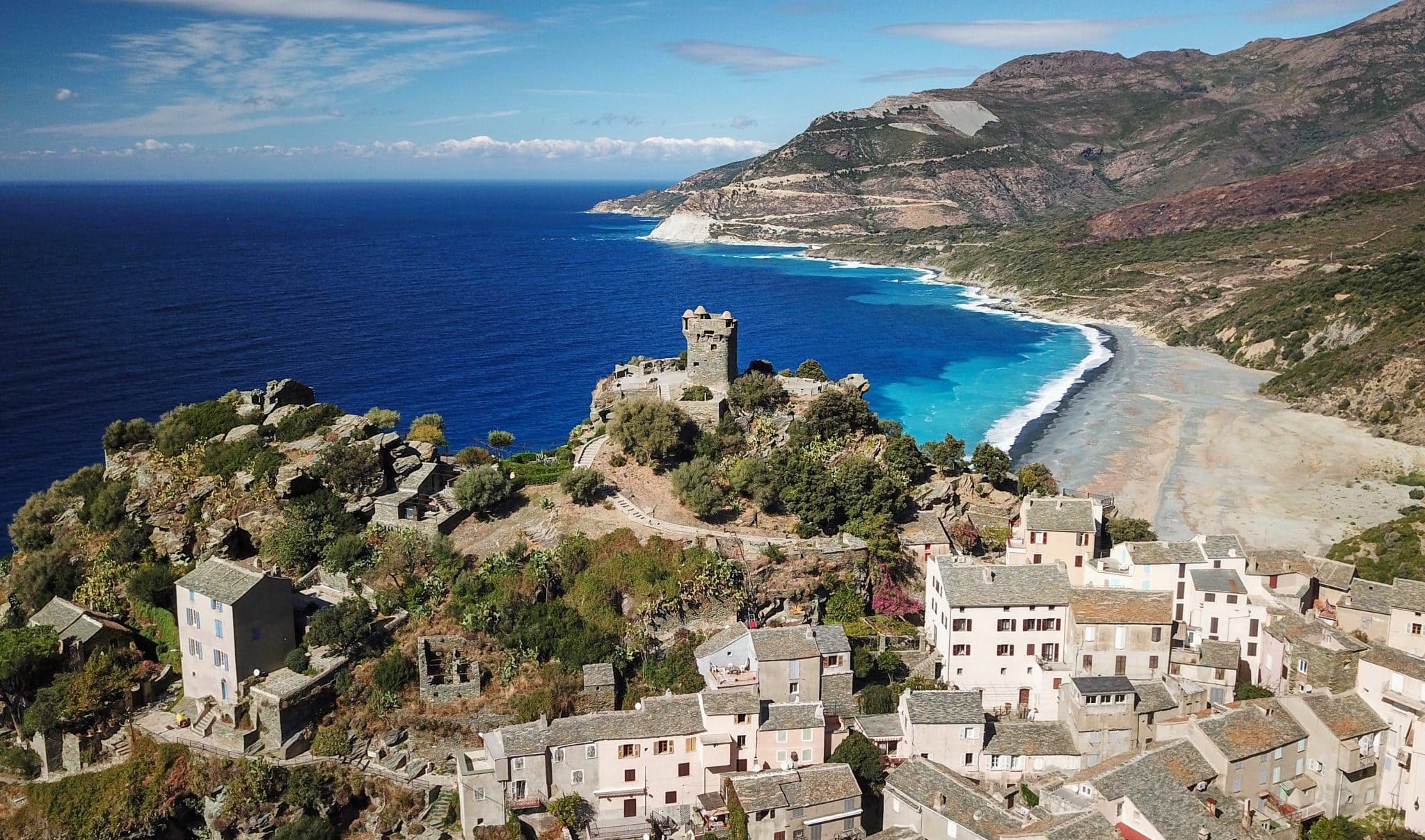 An old town built on top of a hill overlooking the coastline.