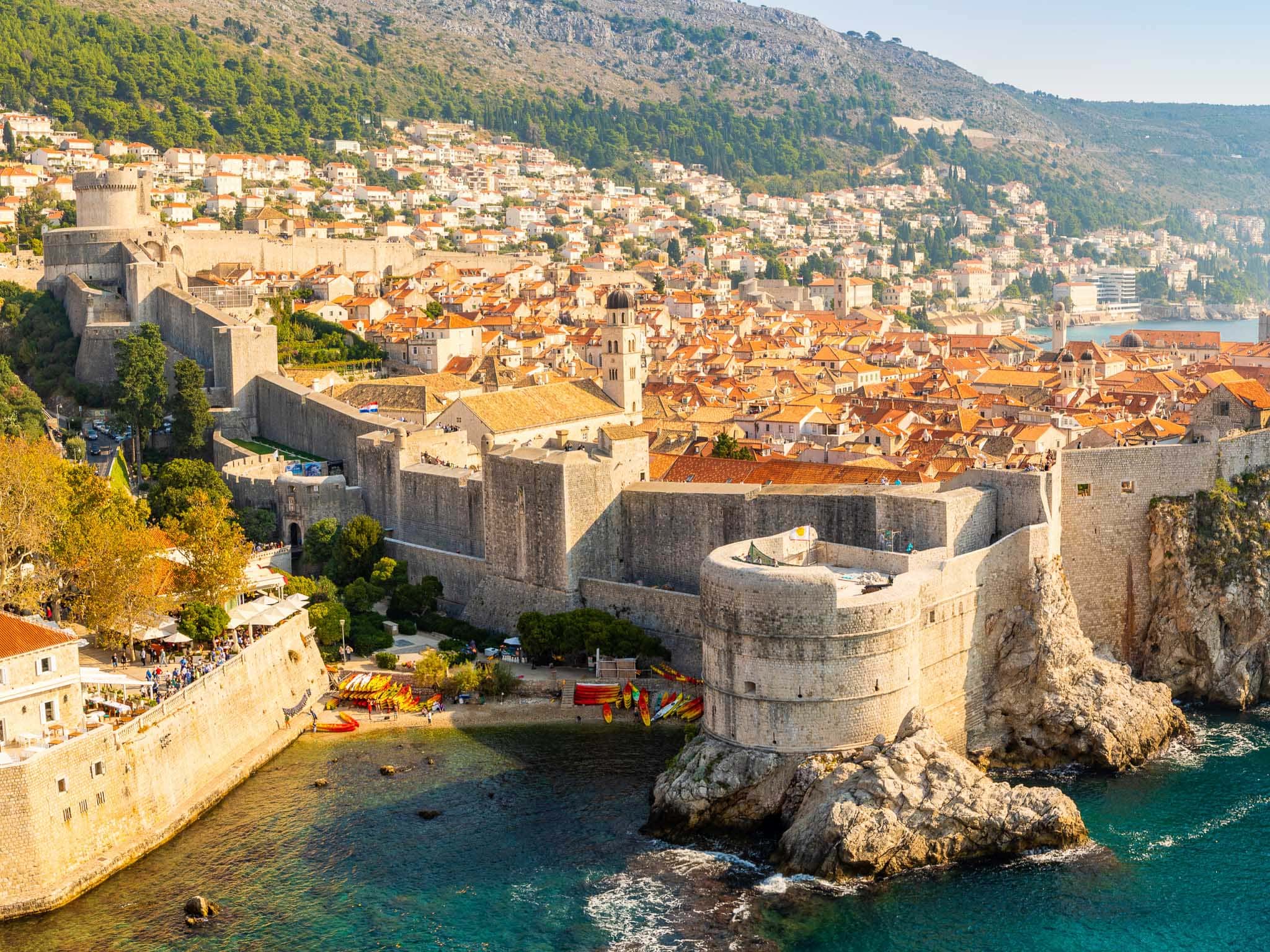 Walled town of Dubrovnik with the sea in the foreground, walls and then the old town behind