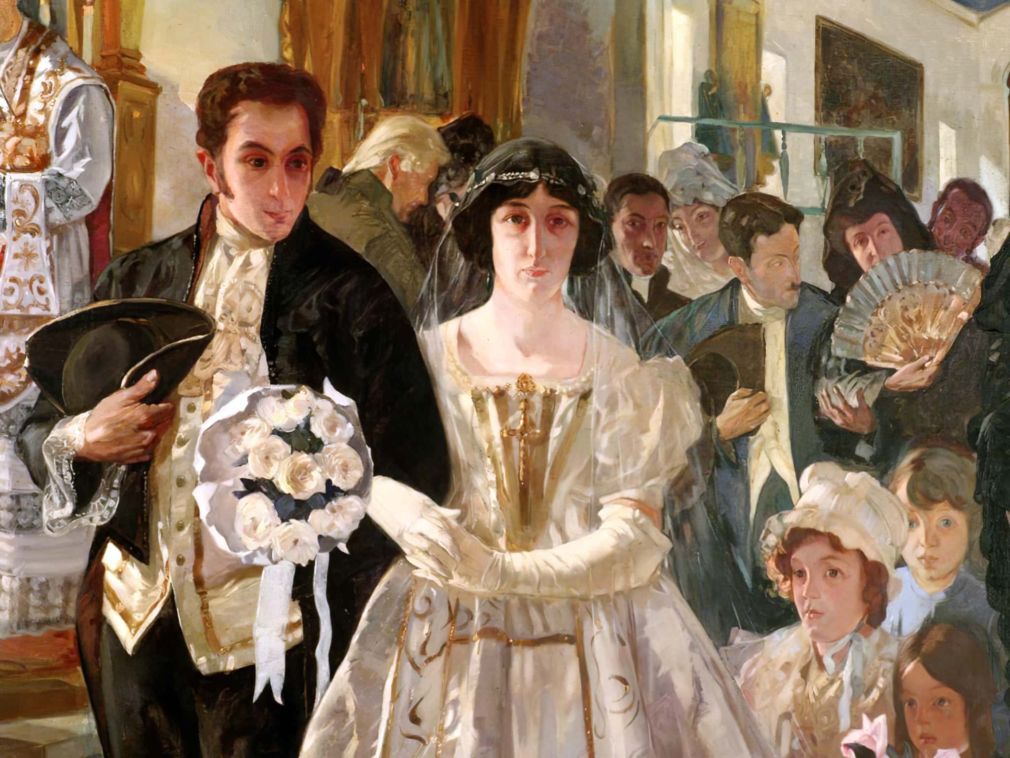 A picture of a historical wedding. The bride and groom walk arm in arm with other guests in the background.