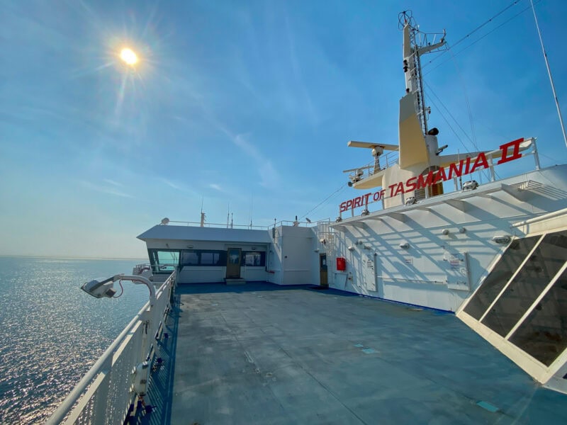 The Spirit of Tasmania taken from the side deck with a bright sun in a clear blue sky behind