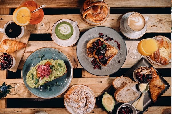 A variety of traditional foods from Norway set out on a timber slatted surface.