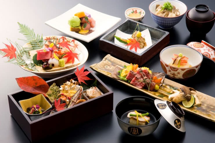 An array of colourful dishes of Japanese style food.