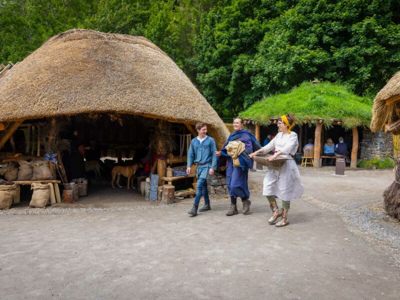 Traditional thatched-roof dwelling with costumed interpreters demonstrating Highland life to visitors.