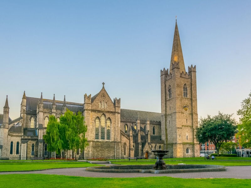 Gothic cathedral spire rising above the historic town of St Andrews with a blue sky behind