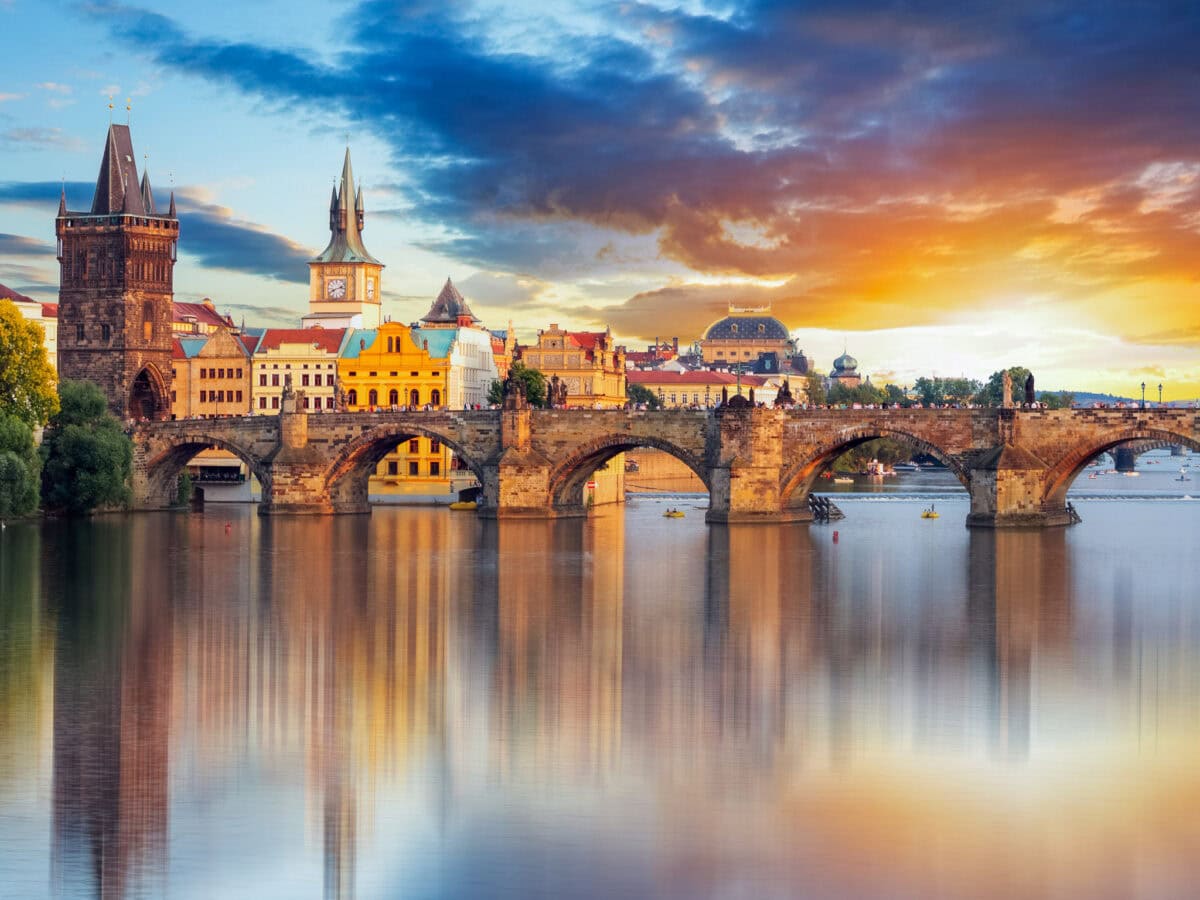 The Charles Bridge with a background of the historic heart of Prague and sunset
