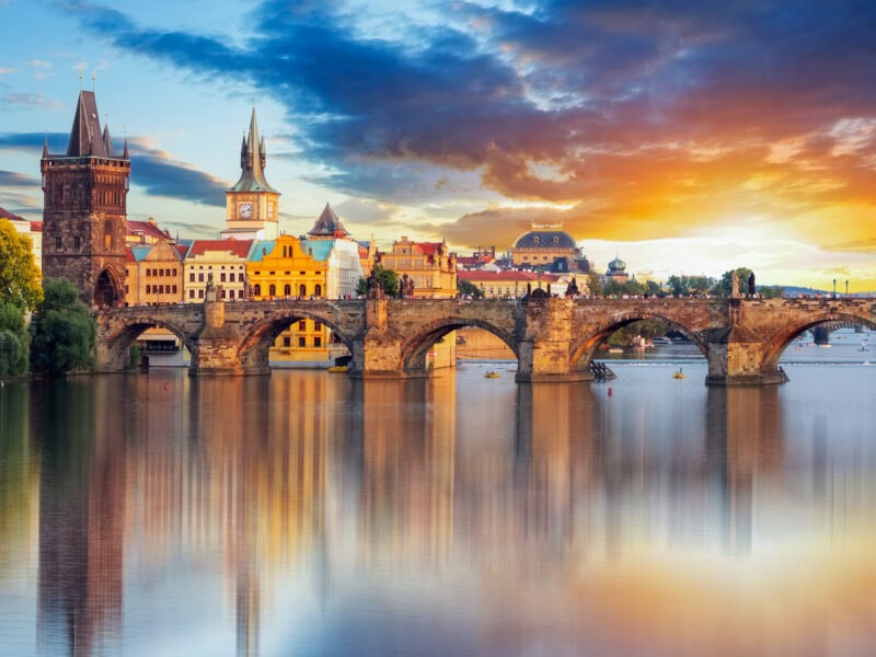 The Charles Bridge with a background of the historic heart of Prague and sunset