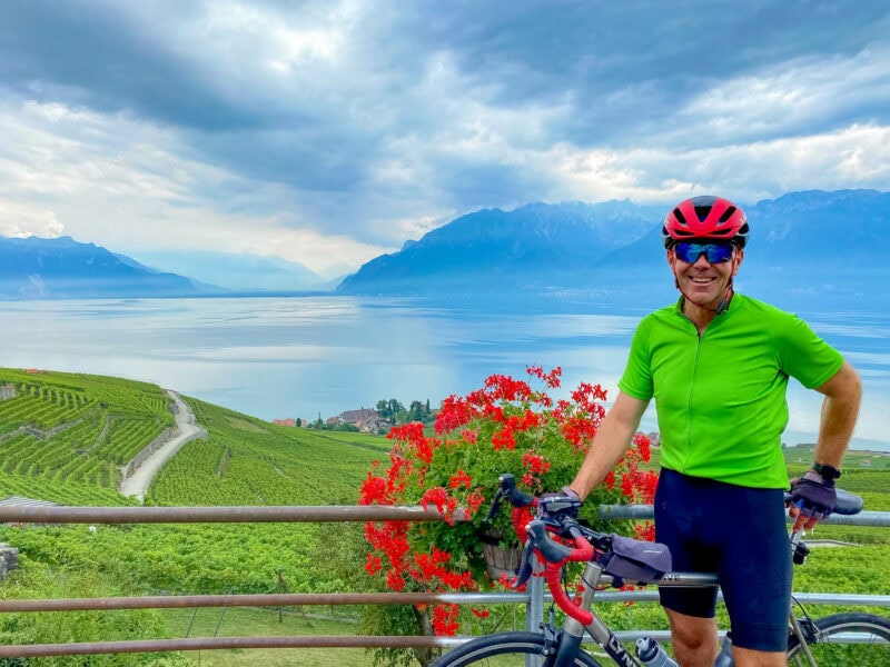 Cyclist overlooking lake and vineyards