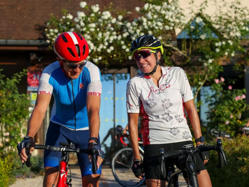 Two cyclists smiling during outdoor ride