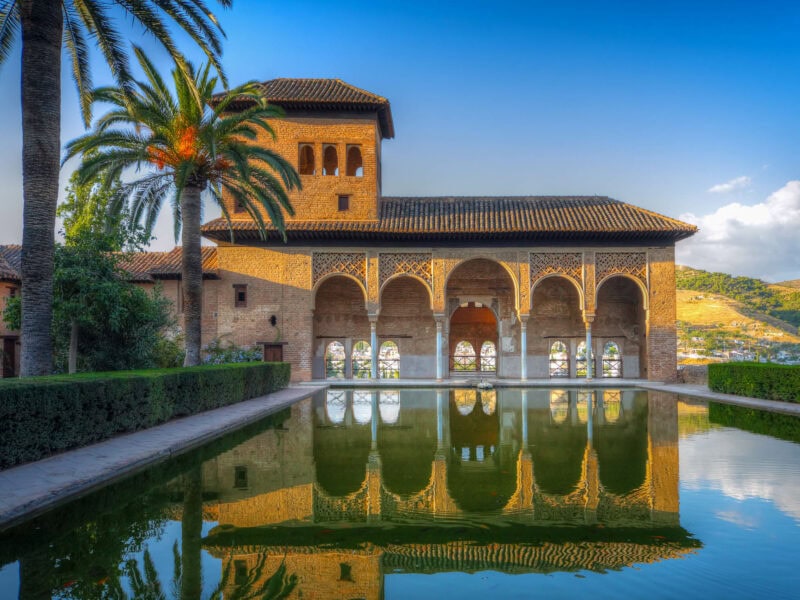 Moorish palace, the Alambra with arches reflected in courtyard pool