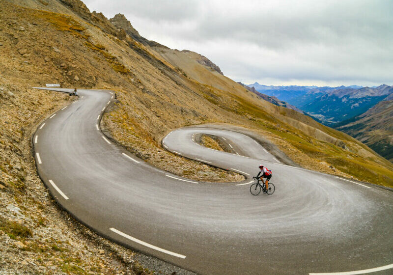 Hannibal Col De Galibier 6966 Cyclist riding up through a series of switch-backs towards the top of Col de Galibier in the Italian Alps