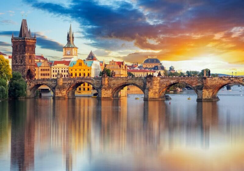 The Charles Bridge with a background of the historic heart of Prague and sunset