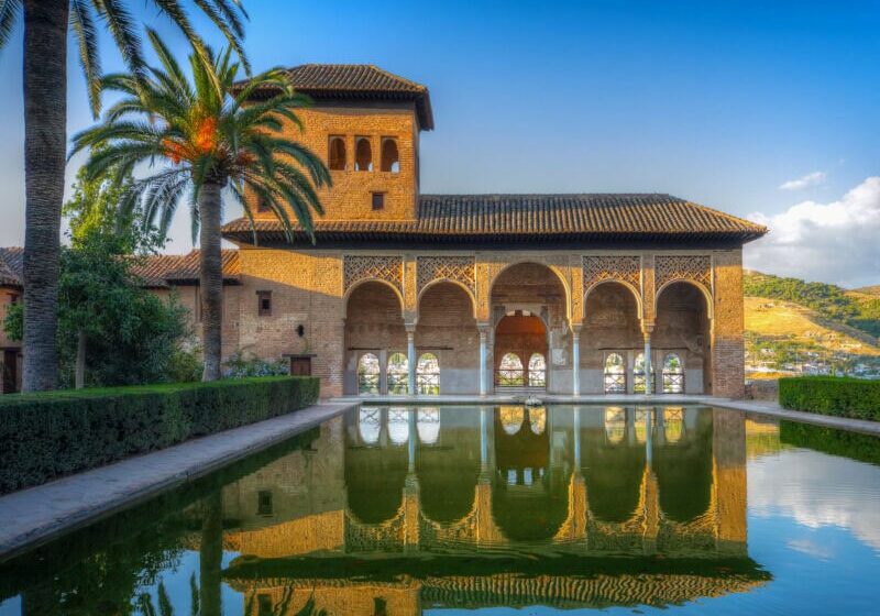 Moorish palace, the Alambra with arches reflected in courtyard pool